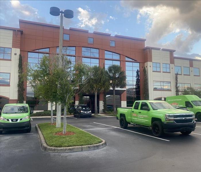 Commercial building with SERVPRO trucks in parking lot