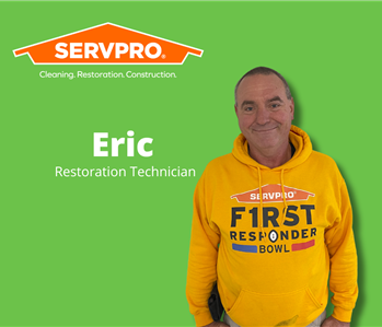 male servpro water damage restoration technician with green background and servpro logo