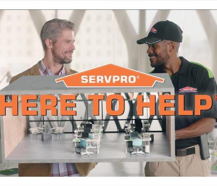 SERVPRO employee consulting a customer